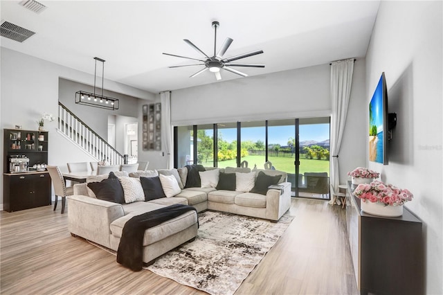 living room with hardwood / wood-style flooring and ceiling fan