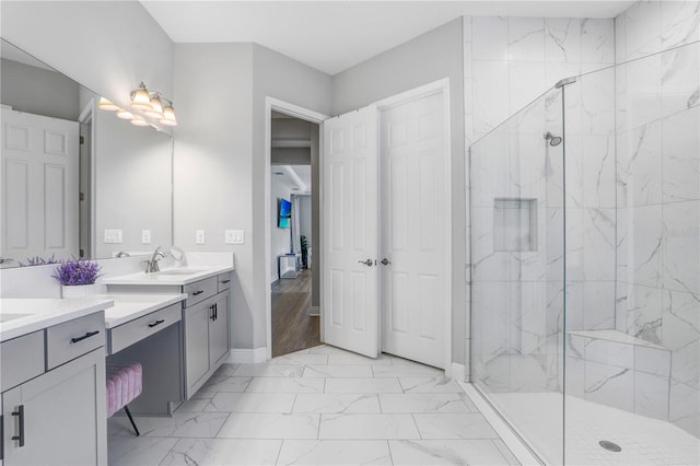 bathroom with a shower with door, tile flooring, double sink, and vanity with extensive cabinet space