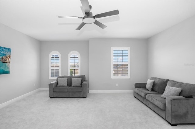 living room with ceiling fan, a wealth of natural light, and carpet flooring