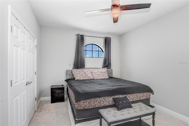 carpeted bedroom featuring a closet and ceiling fan