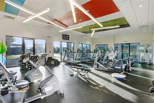 workout area featuring a wealth of natural light and a paneled ceiling