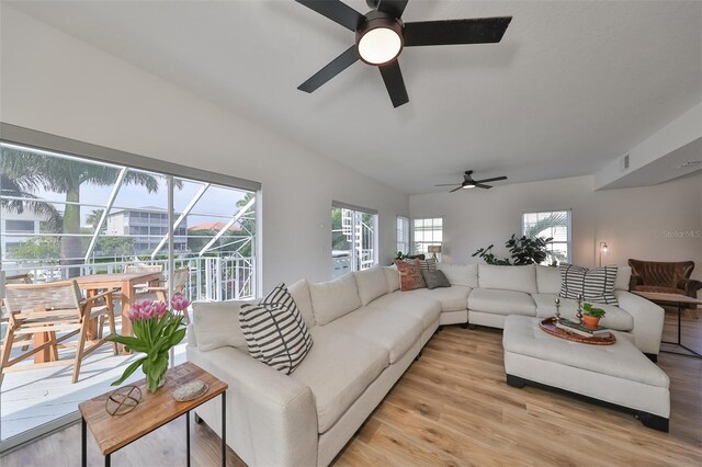 living room featuring a wealth of natural light, light hardwood / wood-style floors, and ceiling fan