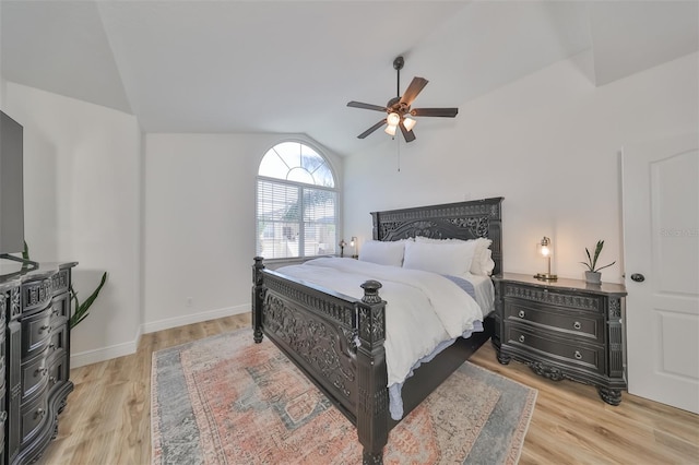 bedroom featuring light hardwood / wood-style floors, lofted ceiling, and ceiling fan