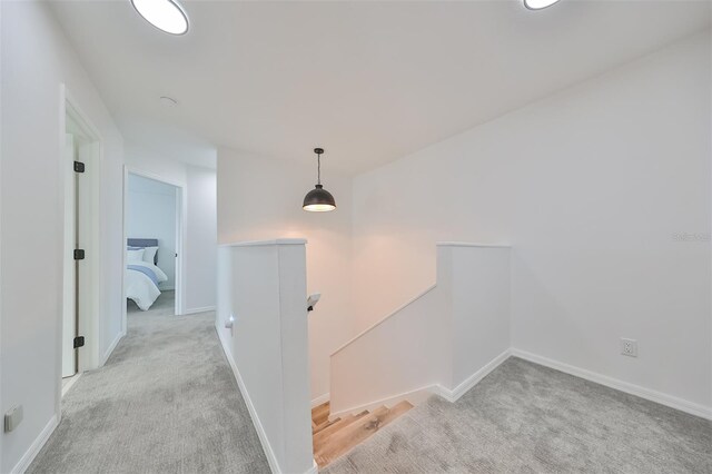 hallway with light colored carpet