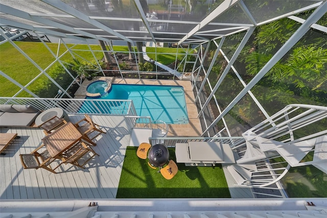 view of pool with a yard and a lanai