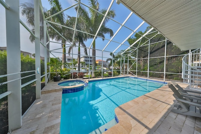 view of pool with an in ground hot tub, a lanai, and a patio area