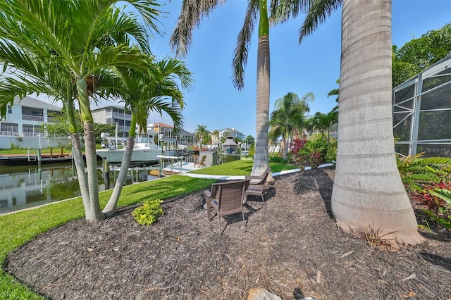 exterior space featuring a lanai, a water view, and a dock