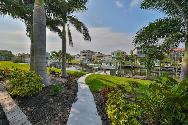 view of home's community featuring a boat dock and a water view