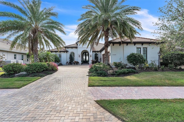 mediterranean / spanish house featuring a front yard