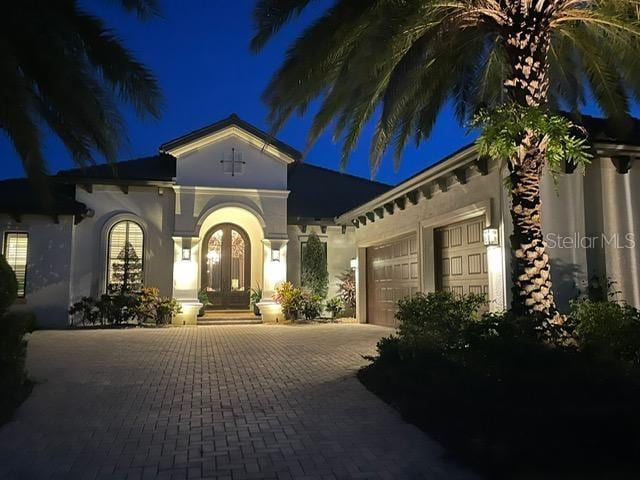 mediterranean / spanish house featuring french doors and a garage