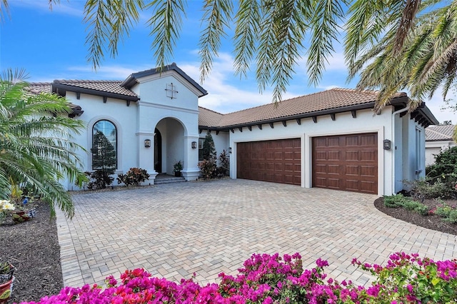 mediterranean / spanish-style home with a garage