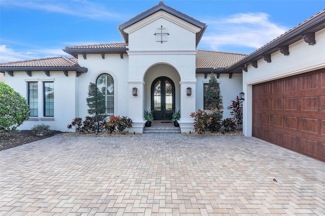 view of front of property featuring a garage and french doors