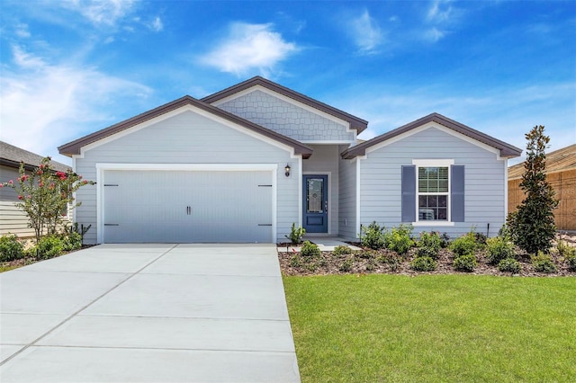 view of front of property with a front lawn and a garage