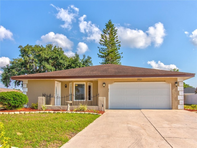 ranch-style house featuring a garage and a front yard