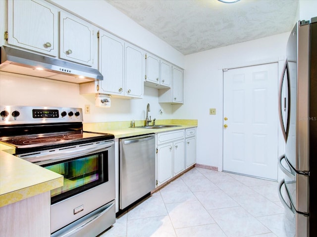 kitchen featuring sink, light tile floors, and stainless steel appliances