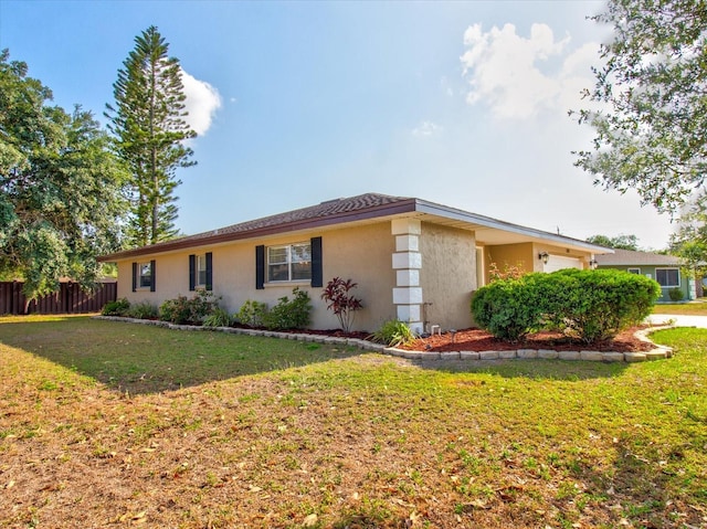 view of side of property with a lawn