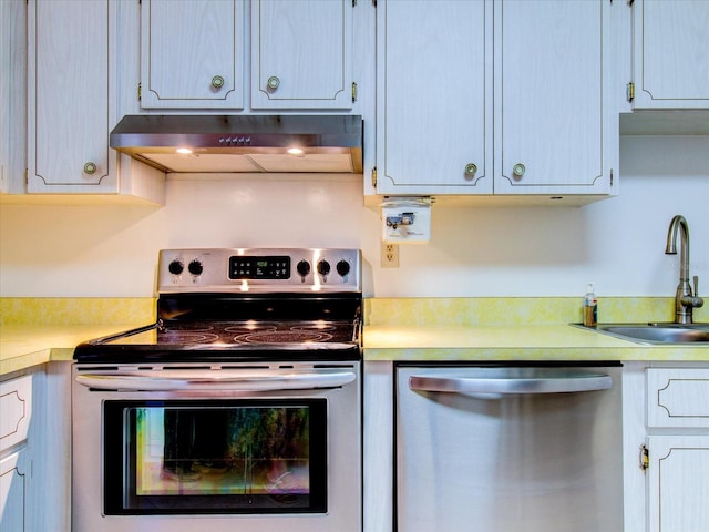 kitchen featuring appliances with stainless steel finishes, sink, and wall chimney exhaust hood