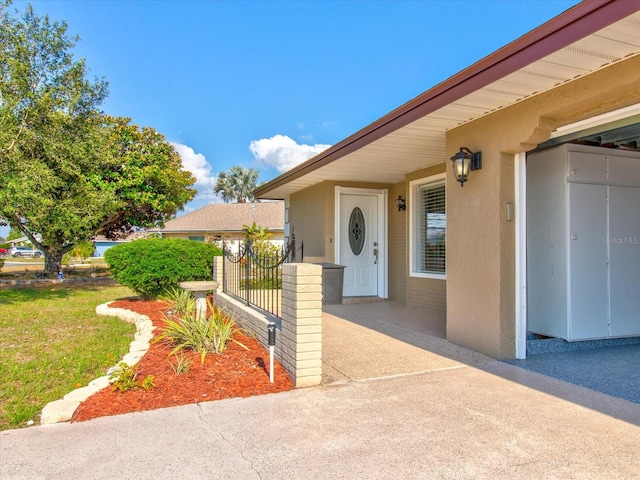 view of exterior entry featuring a yard