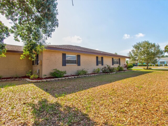 view of side of home with a yard