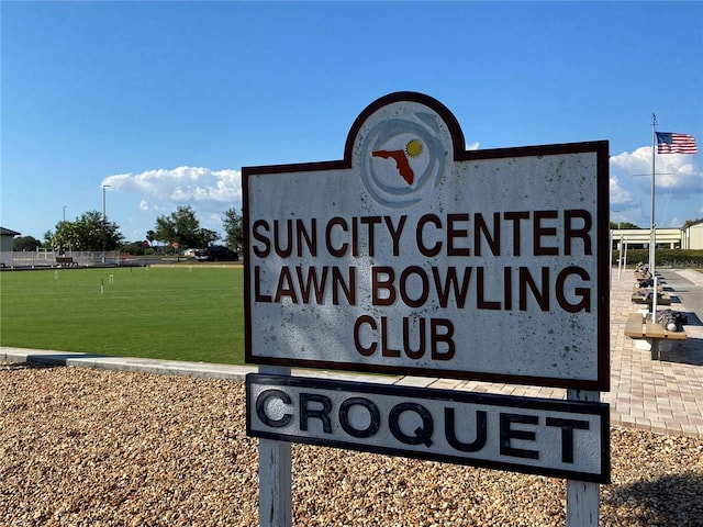 community sign featuring a lawn