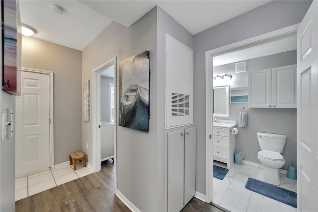 bathroom featuring vanity, toilet, and wood-type flooring