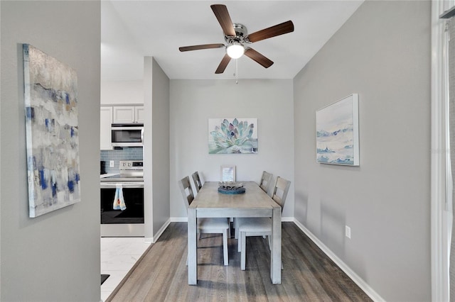 tiled dining room featuring ceiling fan