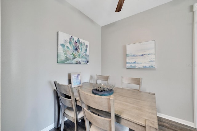 dining space with dark wood-type flooring and ceiling fan