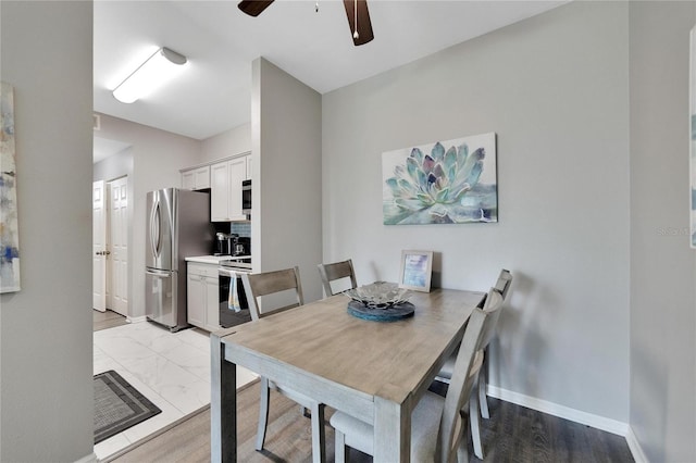 tiled dining area with ceiling fan