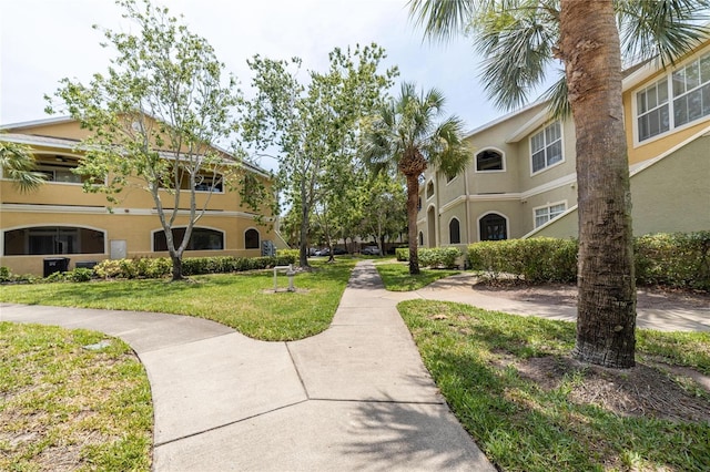 view of home's community with a yard