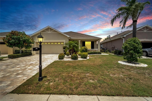 view of front of house with a garage and a lawn