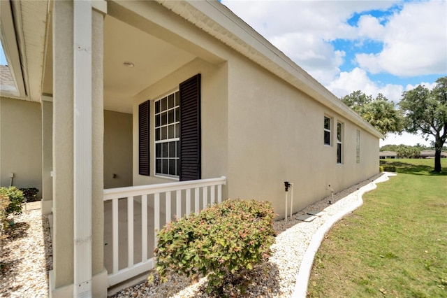 view of side of home with a yard