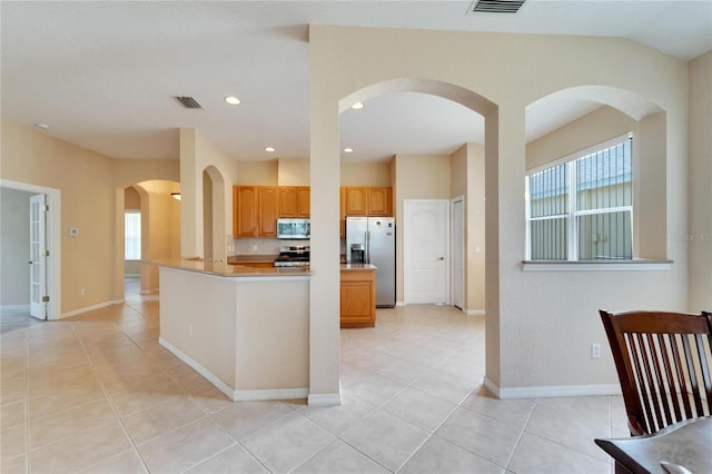 kitchen with stainless steel appliances and light tile flooring