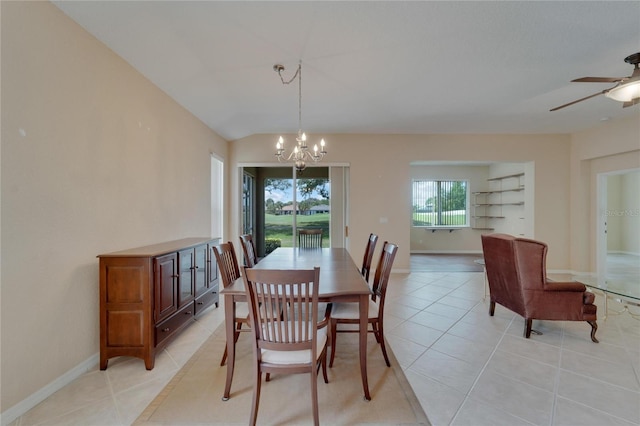 tiled dining area with built in features and ceiling fan with notable chandelier