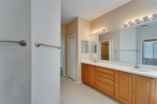 bathroom featuring vanity with extensive cabinet space, double sink, and tile floors