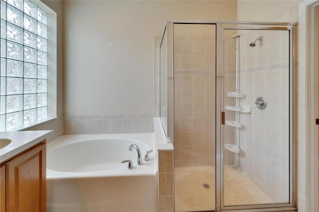 bathroom featuring independent shower and bath and vanity