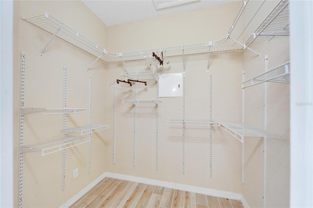 spacious closet with light hardwood / wood-style flooring