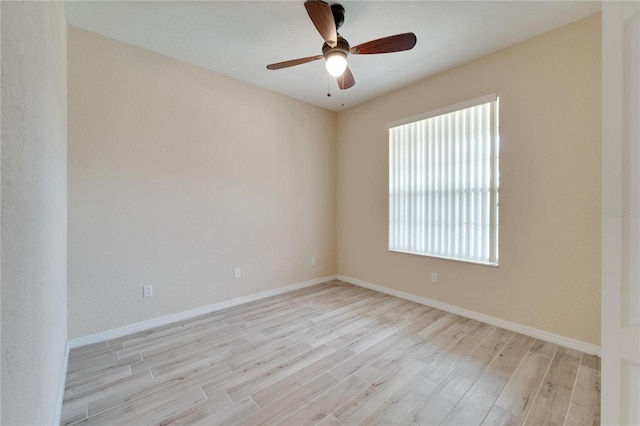 spare room with light hardwood / wood-style floors and ceiling fan