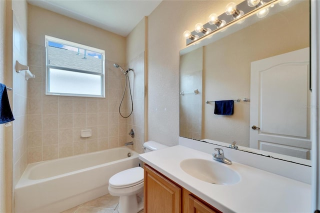 full bathroom with tile floors, vanity, toilet, and tiled shower / bath combo