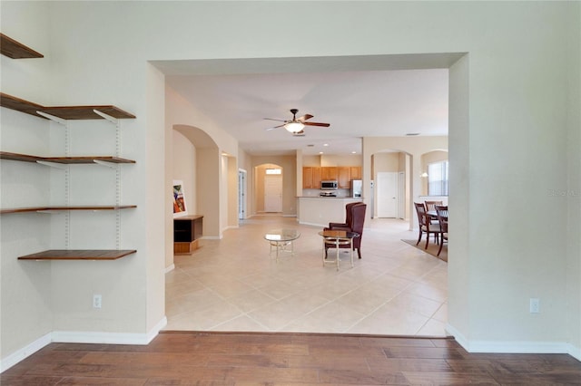 unfurnished dining area with ceiling fan and light hardwood / wood-style flooring