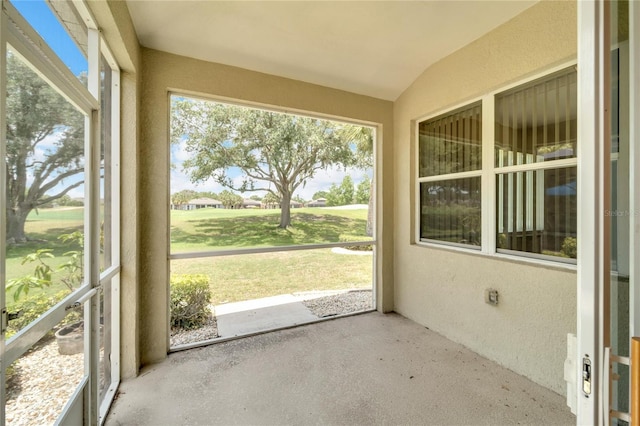 unfurnished sunroom with lofted ceiling