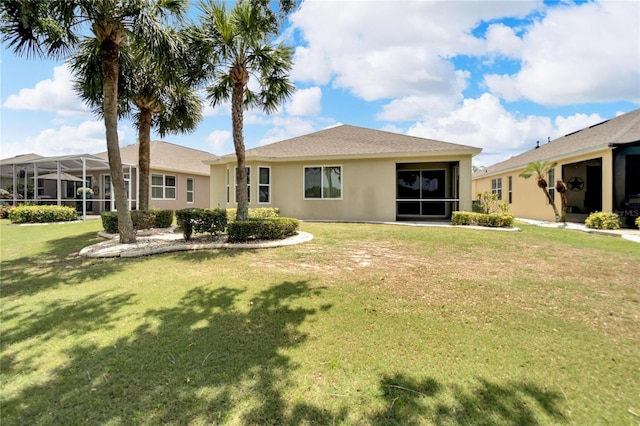 back of property with a lanai and a lawn