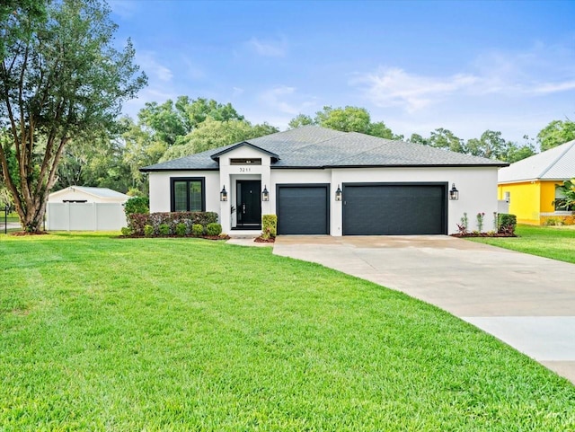 view of front of property featuring a garage and a front yard