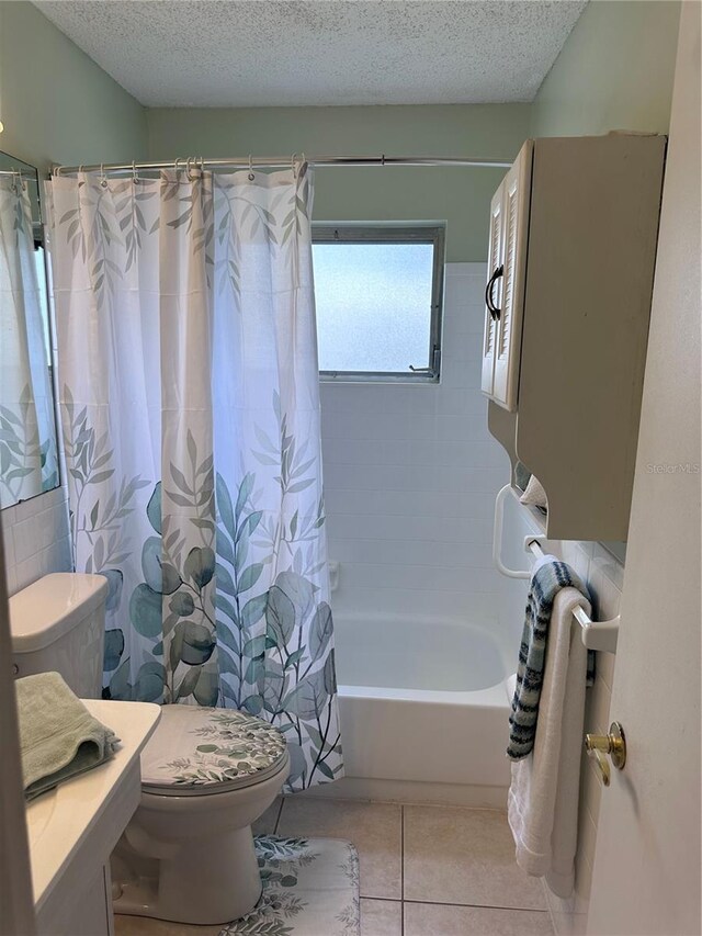 full bathroom with shower / bathtub combination with curtain, vanity, a textured ceiling, tile patterned flooring, and toilet