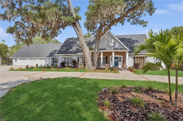 view of front of house with a front lawn and a garage