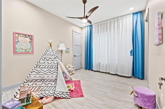 rec room featuring ceiling fan and light hardwood / wood-style flooring