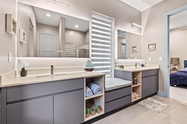 bathroom with walk in shower, tile patterned floors, and vanity