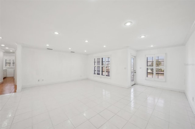 unfurnished living room with light tile patterned flooring, baseboards, ornamental molding, and recessed lighting