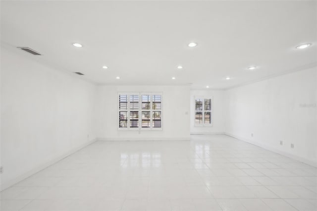 empty room featuring recessed lighting, visible vents, and baseboards