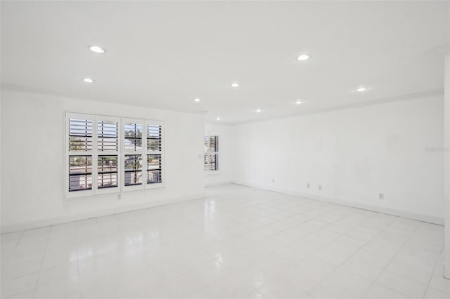 unfurnished room with recessed lighting and baseboards