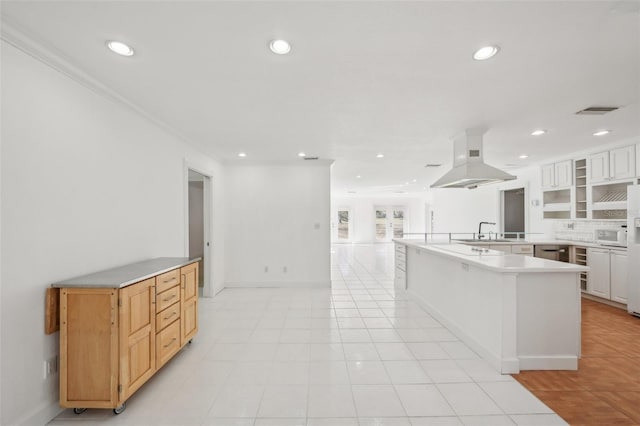 kitchen featuring recessed lighting, light countertops, open floor plan, white cabinetry, and island range hood